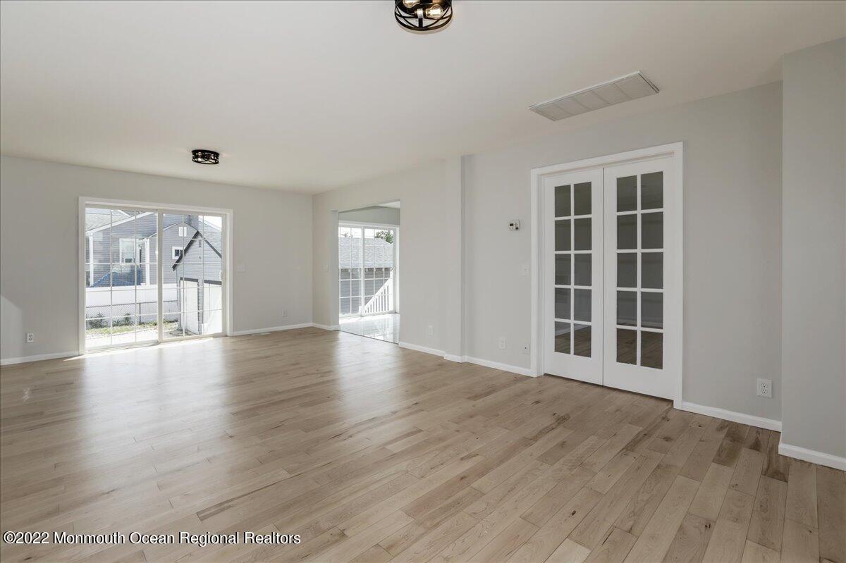 110 Island Road Toms River, NJ 08753 - Photo 11 of 51 a view of an empty room with wooden floor and a window
