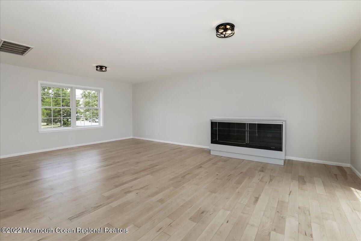 110 Island Road Toms River, NJ 08753 - Photo 12 of 51 an empty room with wooden floor and windows