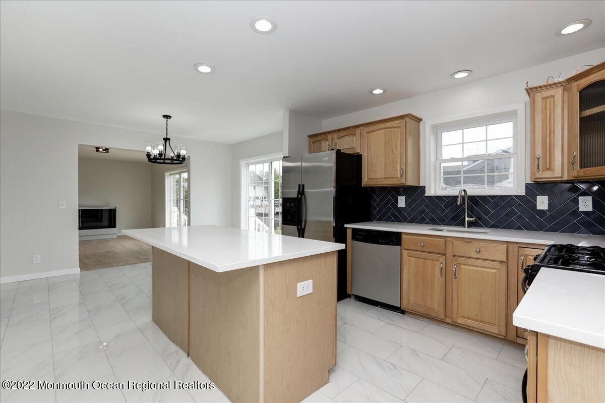 110 Island Road Toms River, NJ 08753 - Photo 22 of 51 a kitchen with stainless steel appliances kitchen island granite countertop a sink and a stove