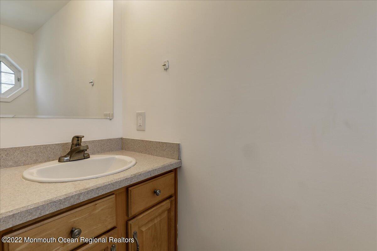 110 Island Road Toms River, NJ 08753 - Photo 24 of 51 a bathroom with a sink and a mirror