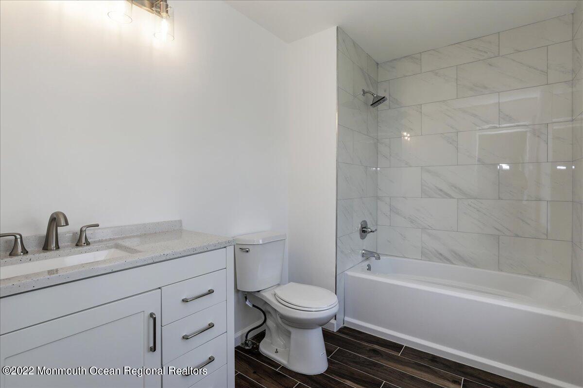 110 Island Road Toms River, NJ 08753 - Photo 28 of 51 a bathroom with a granite countertop toilet a sink and a bathtub