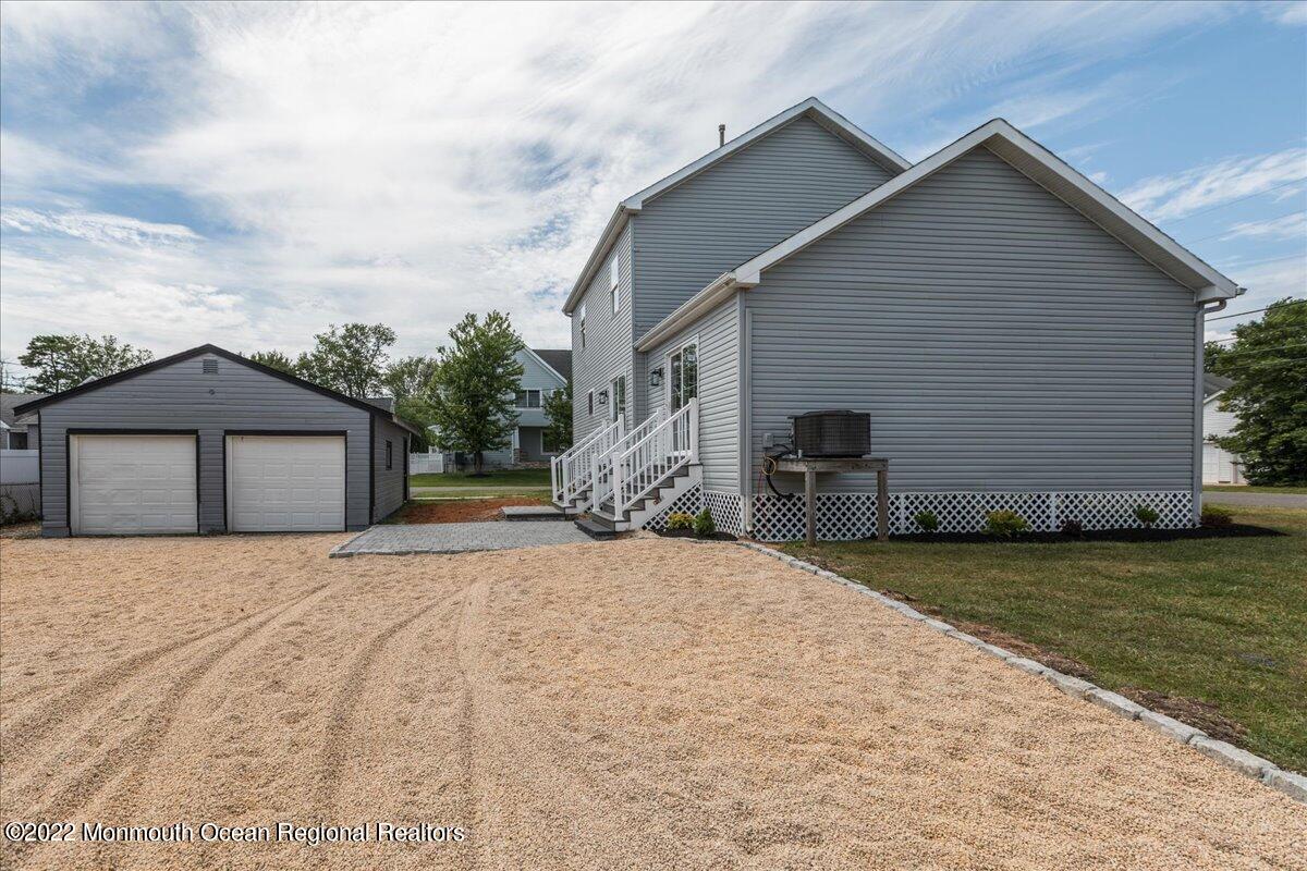 110 Island Road Toms River, NJ 08753 - Photo 38 of 51 a front view of a house with a yard and garage