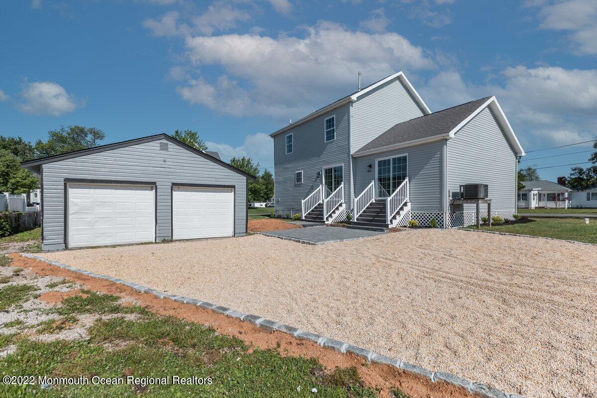 110 Island Road Toms River, NJ 08753 - Photo 39 of 51 a front view of a house with a yard and garage