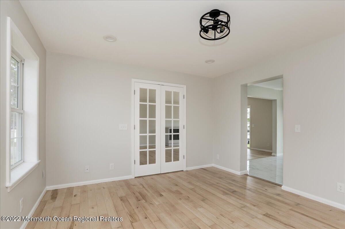 110 Island Road Toms River, NJ 08753 - Photo 7 of 51 an empty room with wooden floor and windows