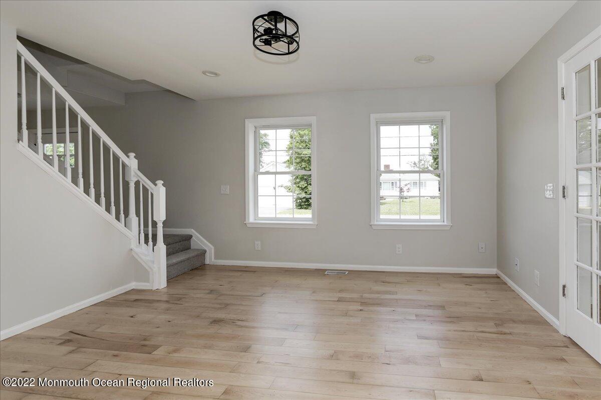110 Island Road Toms River, NJ 08753 - Photo 9 of 51 an empty room with wooden floor and windows