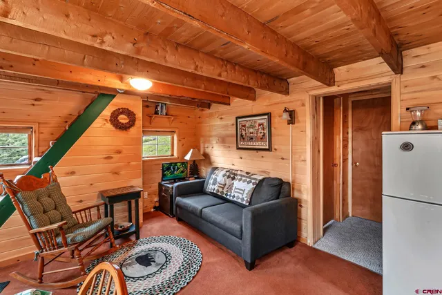 a outdoor living room with furniture and a ceiling fan