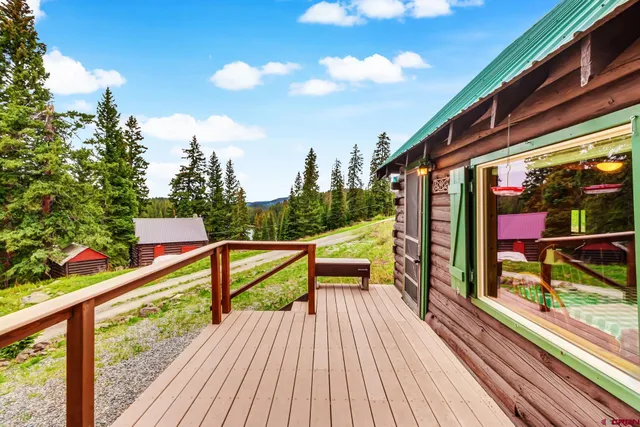 a view of deck with furniture and garden