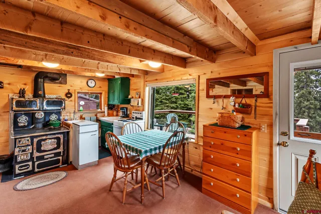 a view of a dining room with furniture and chandelier