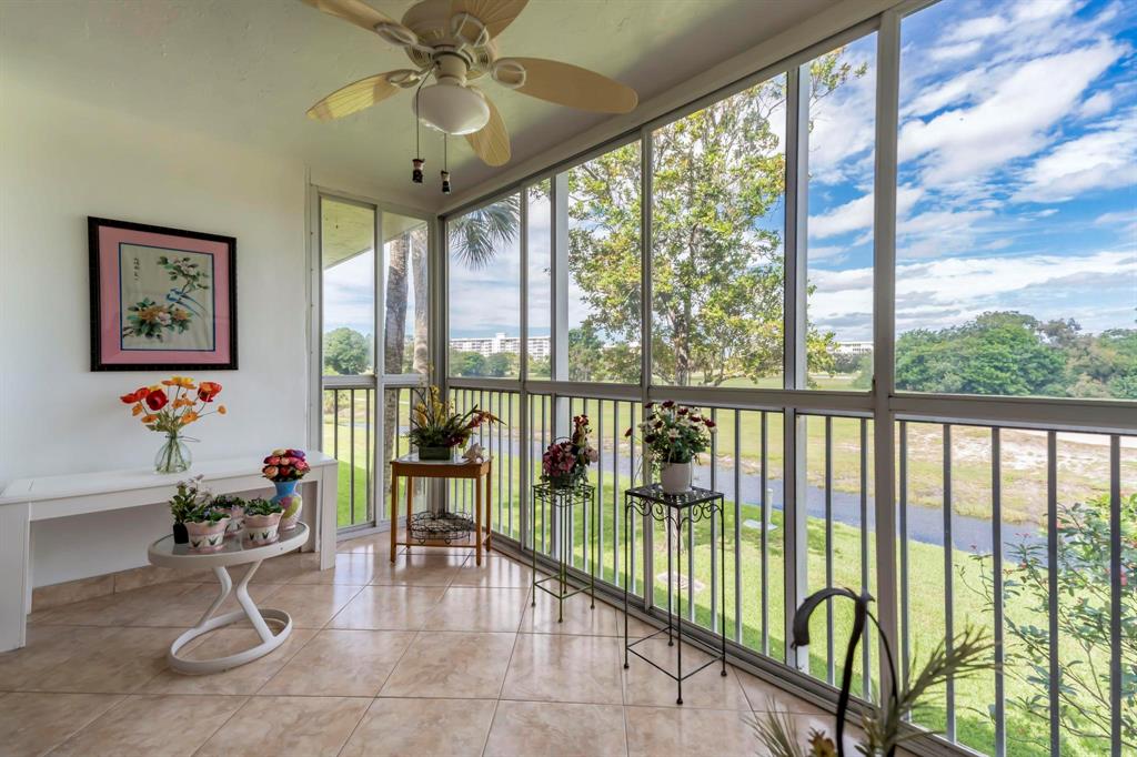 a living room with furniture and floor to ceiling windows