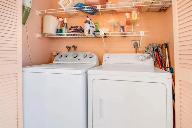 a dining room with furniture a chandelier and wooden floor