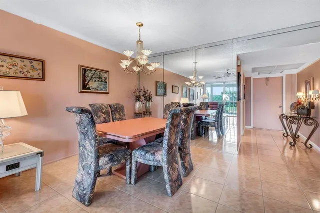 a living room with furniture a flat screen tv and a floor to ceiling window