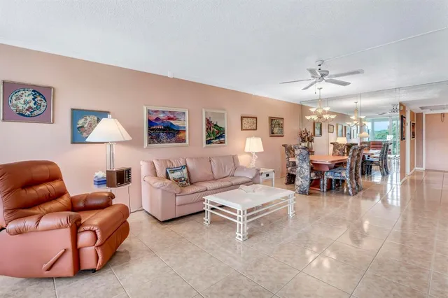 a living room with furniture a dining table and chairs with wooden floor