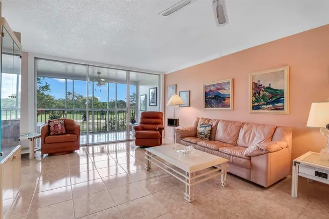 a bedroom with a bed flat screen tv and a chandelier