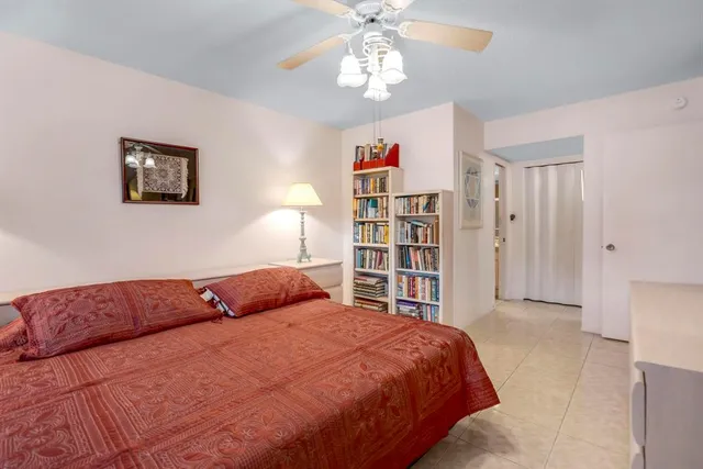a bedroom with furniture and a large window