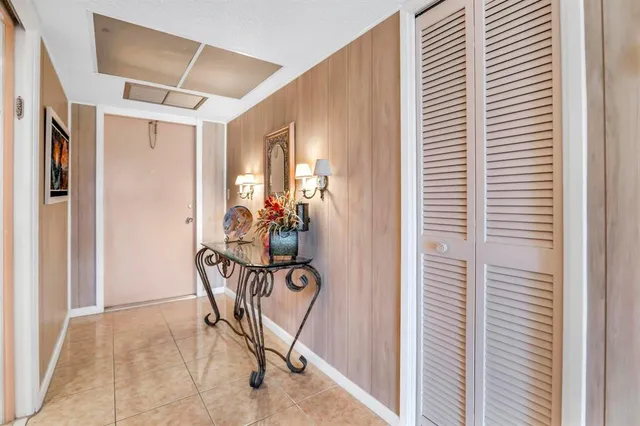 a kitchen with stainless steel appliances kitchen island granite countertop a refrigerator a stove and white cabinets with wooden floor