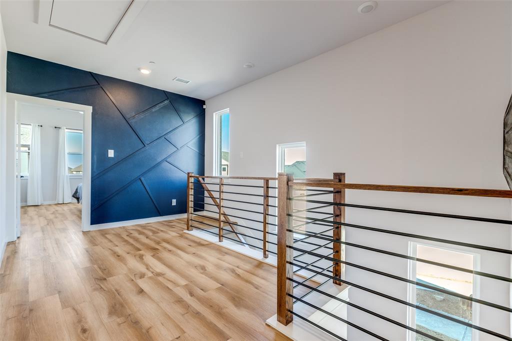 720 Bandera Court Prosper, TX 75078 - Photo 10 of 24 a view of a big room with wooden floor and stairs