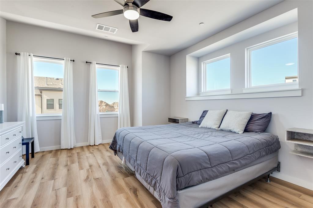 720 Bandera Court Prosper, TX 75078 - Photo 14 of 24 a bedroom with a large bed and a window