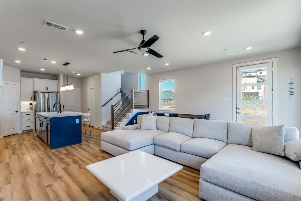 720 Bandera Court Prosper, TX 75078 - Photo 24 of 24 a living room with furniture kitchen view and a wooden floor