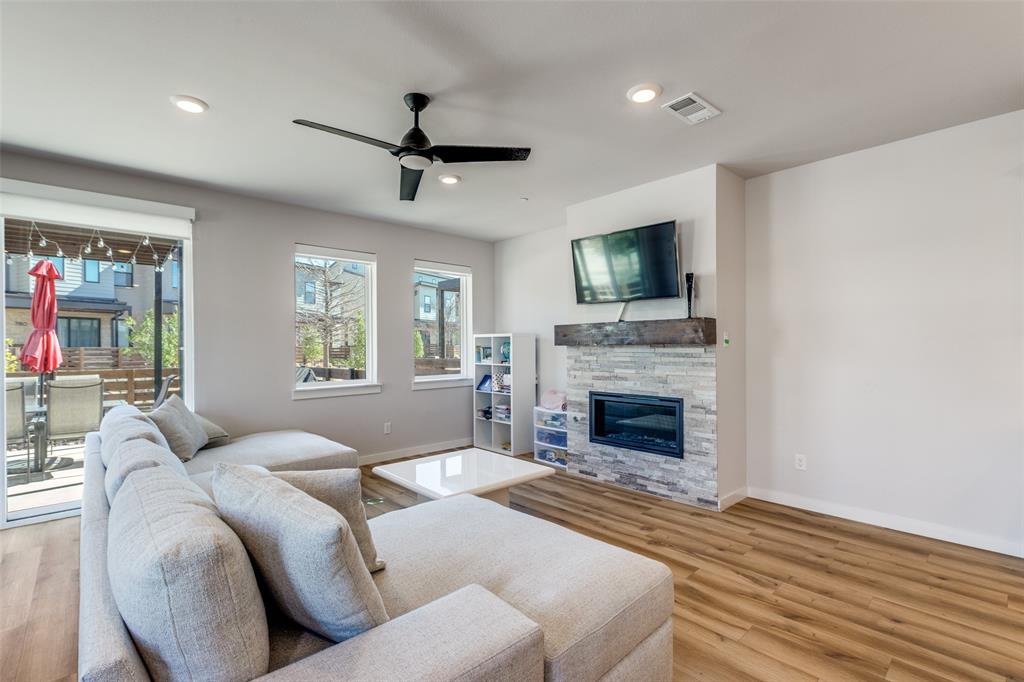 720 Bandera Court Prosper, TX 75078 - Photo 4 of 24 a living room with furniture a fireplace and a flat screen tv