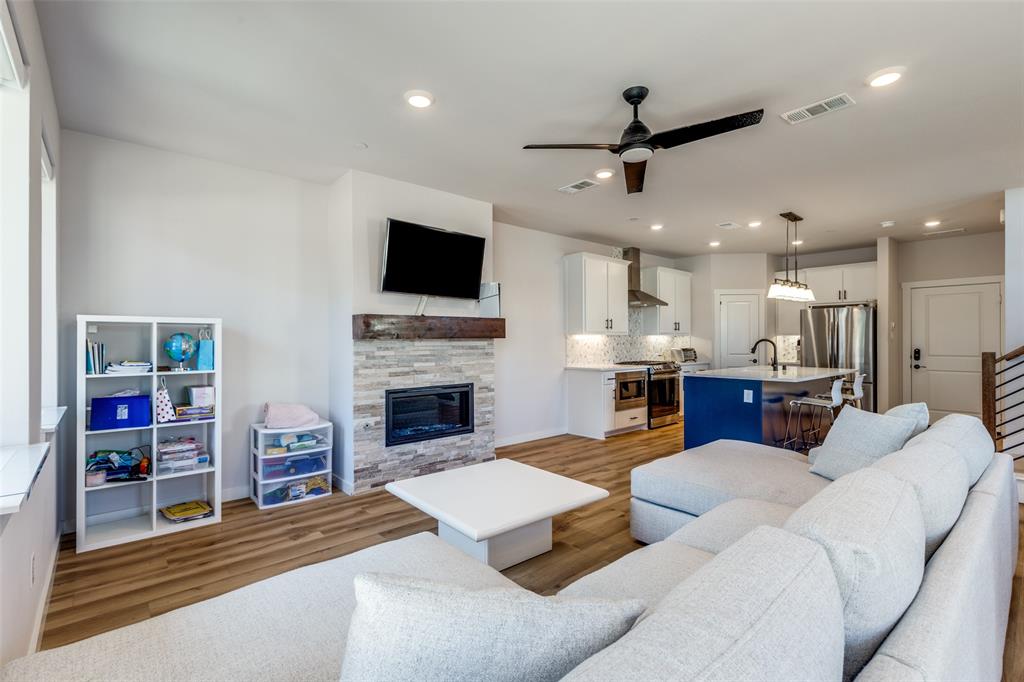 720 Bandera Court Prosper, TX 75078 - Photo 5 of 24 a living room with furniture and a fireplace