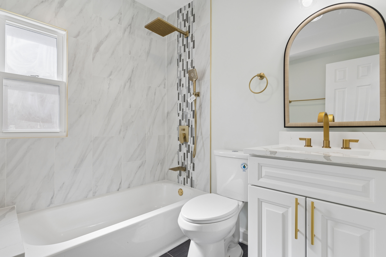 6347 South Kenneth Avenue Chicago, IL 60629 - Photo 20 of 40 a bathroom with a sink a toilet a mirror a vanity and bathtub