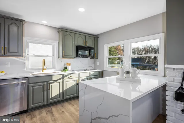 a kitchen with a sink window and cabinets