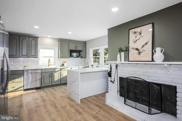 a open kitchen with granite countertop a stove top oven sink and cabinets