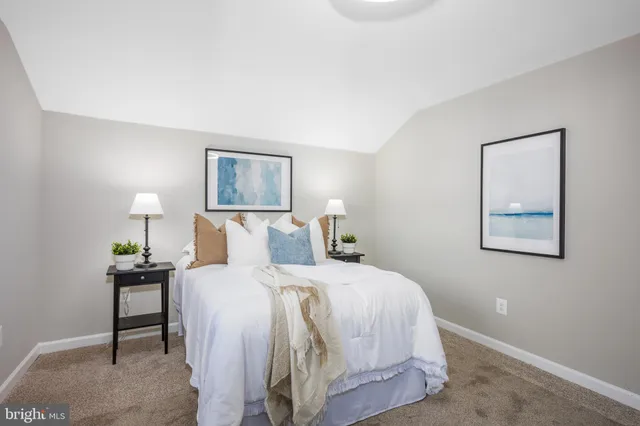 a spacious bedroom with a bed and a window