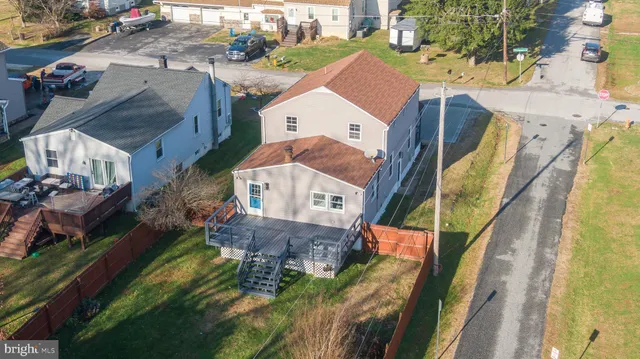 an aerial view of a house with a garden and swimming pool