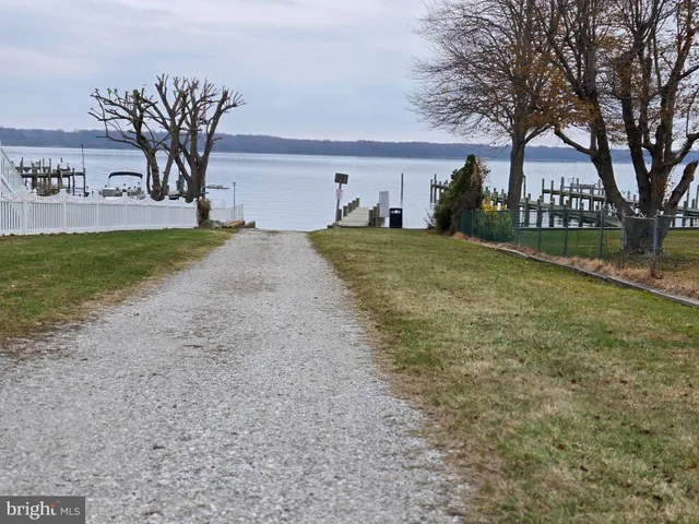 a view of a house with garden and trees