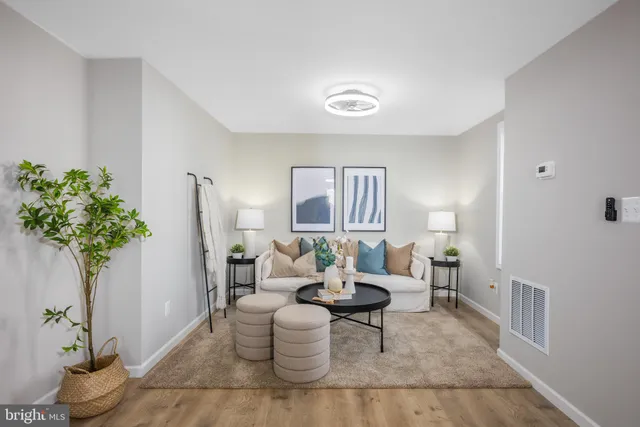 a living room with furniture and a potted plant