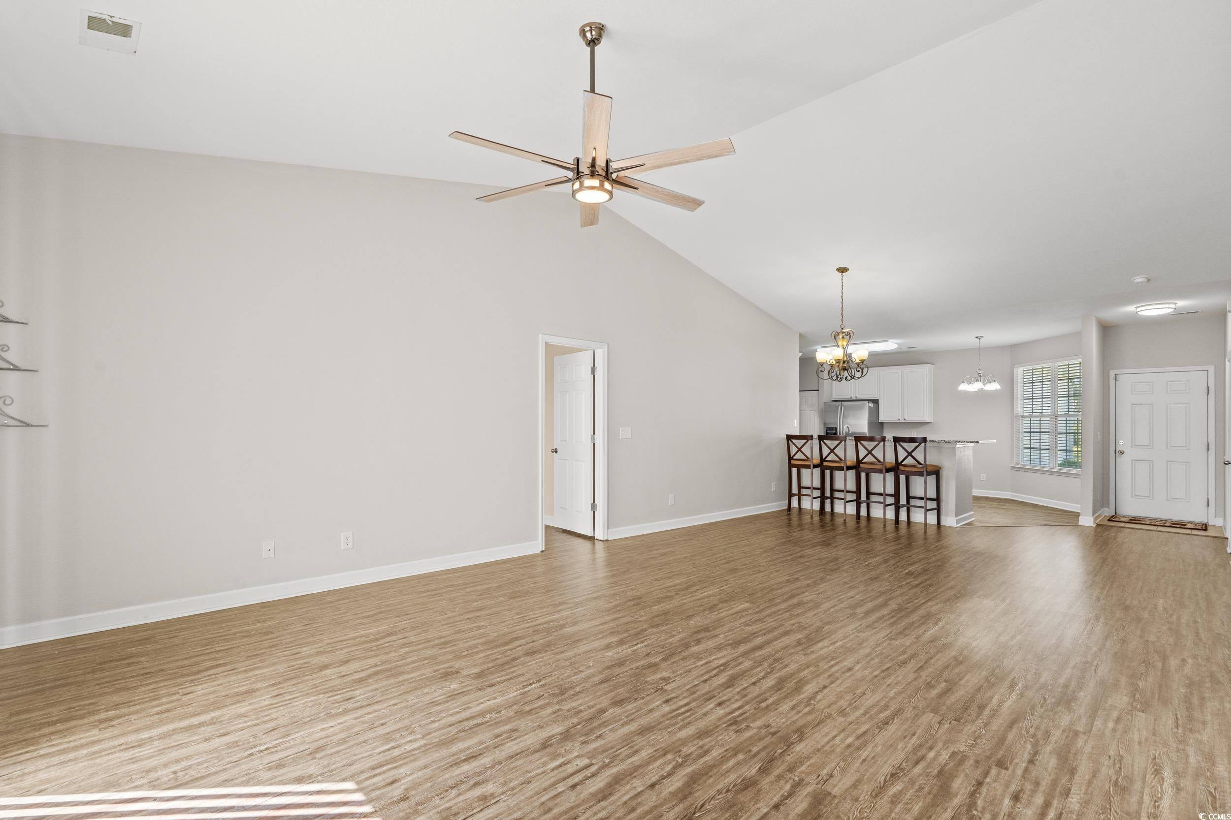 562 Tuckahoe Road Myrtle Beach, SC 29579 - Photo 13 of 40 Unfurnished living room featuring light wood finished floors, a chandelier, high vaulted ceiling, and ceiling fan