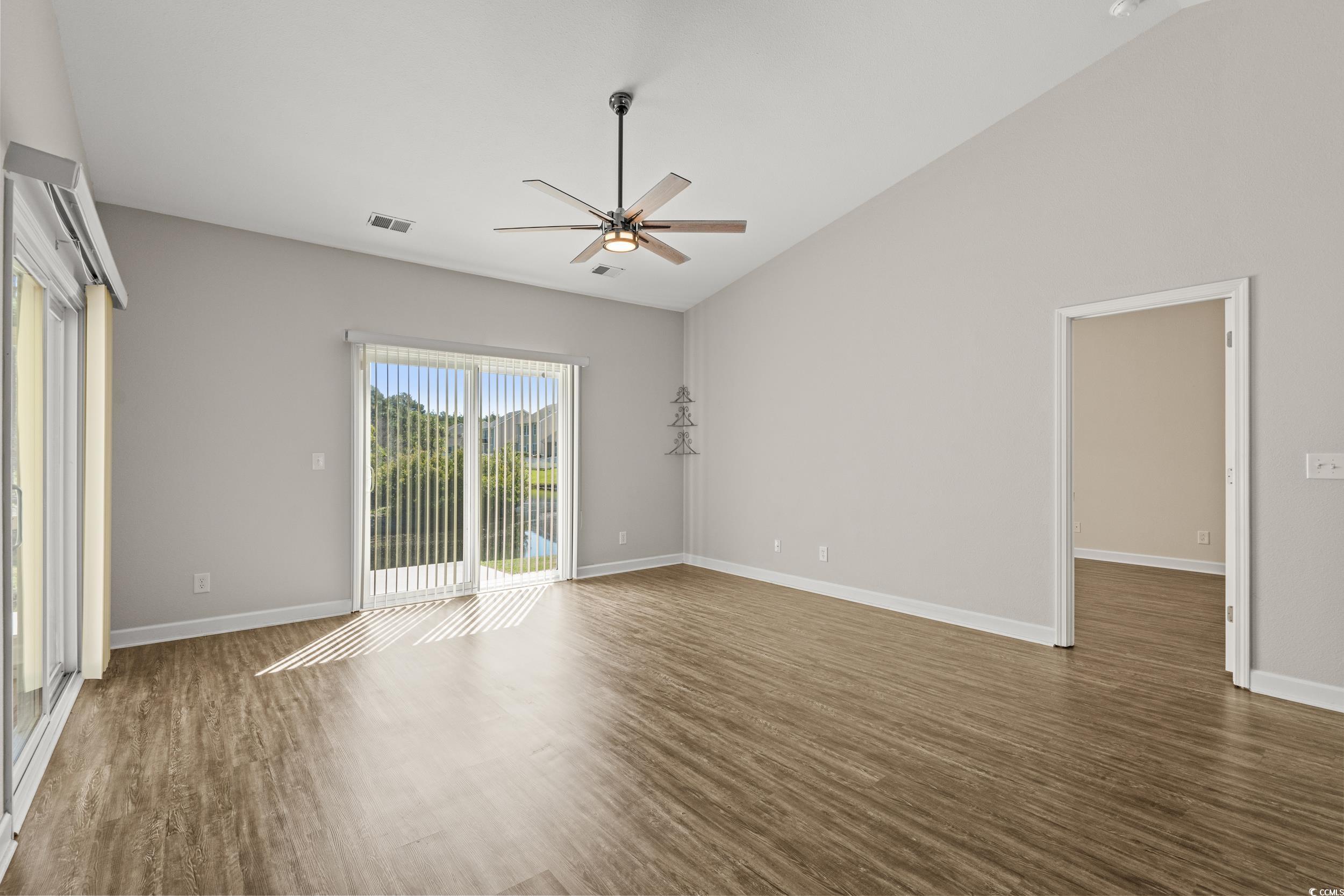 562 Tuckahoe Road Myrtle Beach, SC 29579 - Photo 15 of 40 Unfurnished room with dark wood-style floors, ceiling fan, and vaulted ceiling