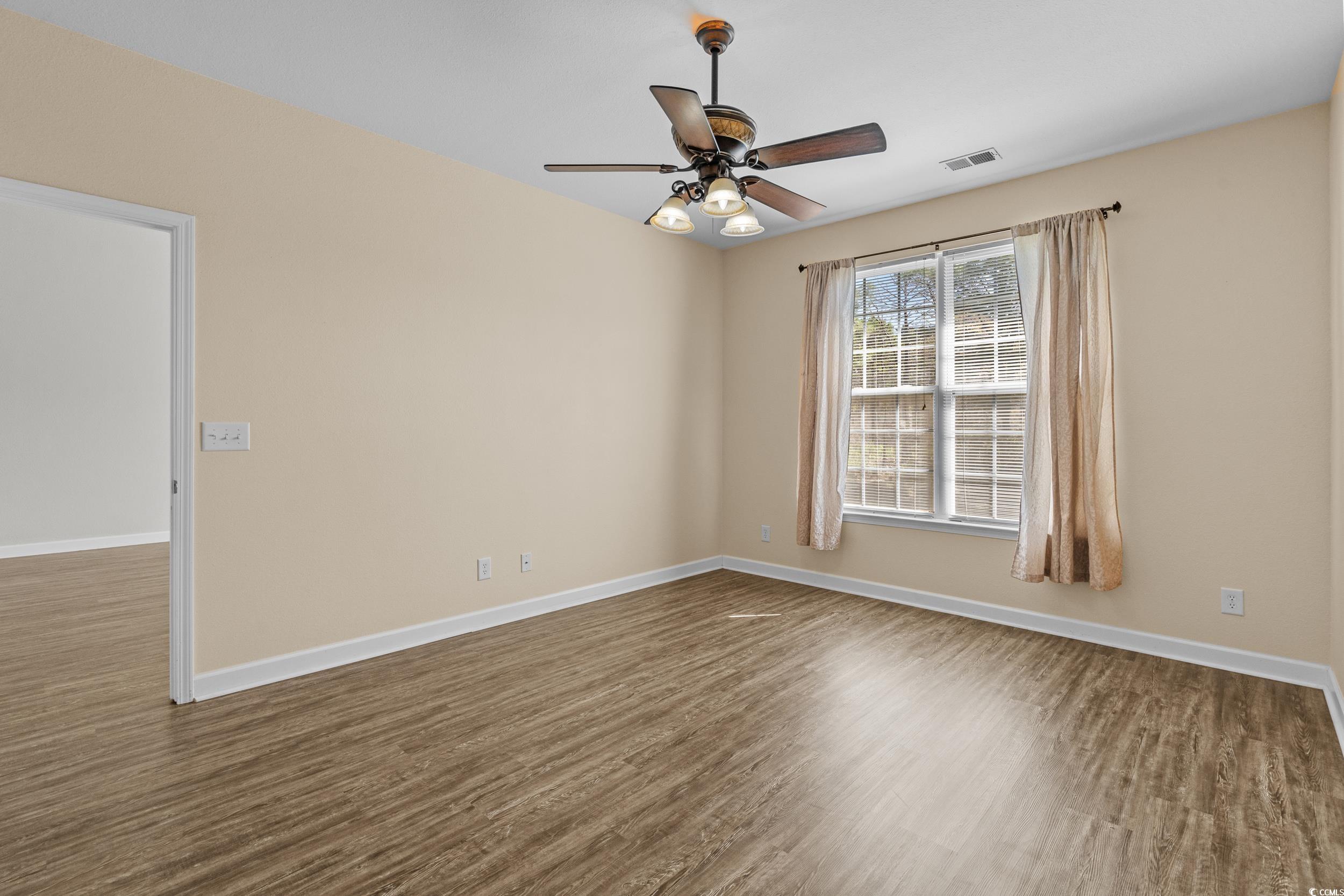 562 Tuckahoe Road Myrtle Beach, SC 29579 - Photo 17 of 40 Spare room featuring dark wood-style flooring and ceiling fan