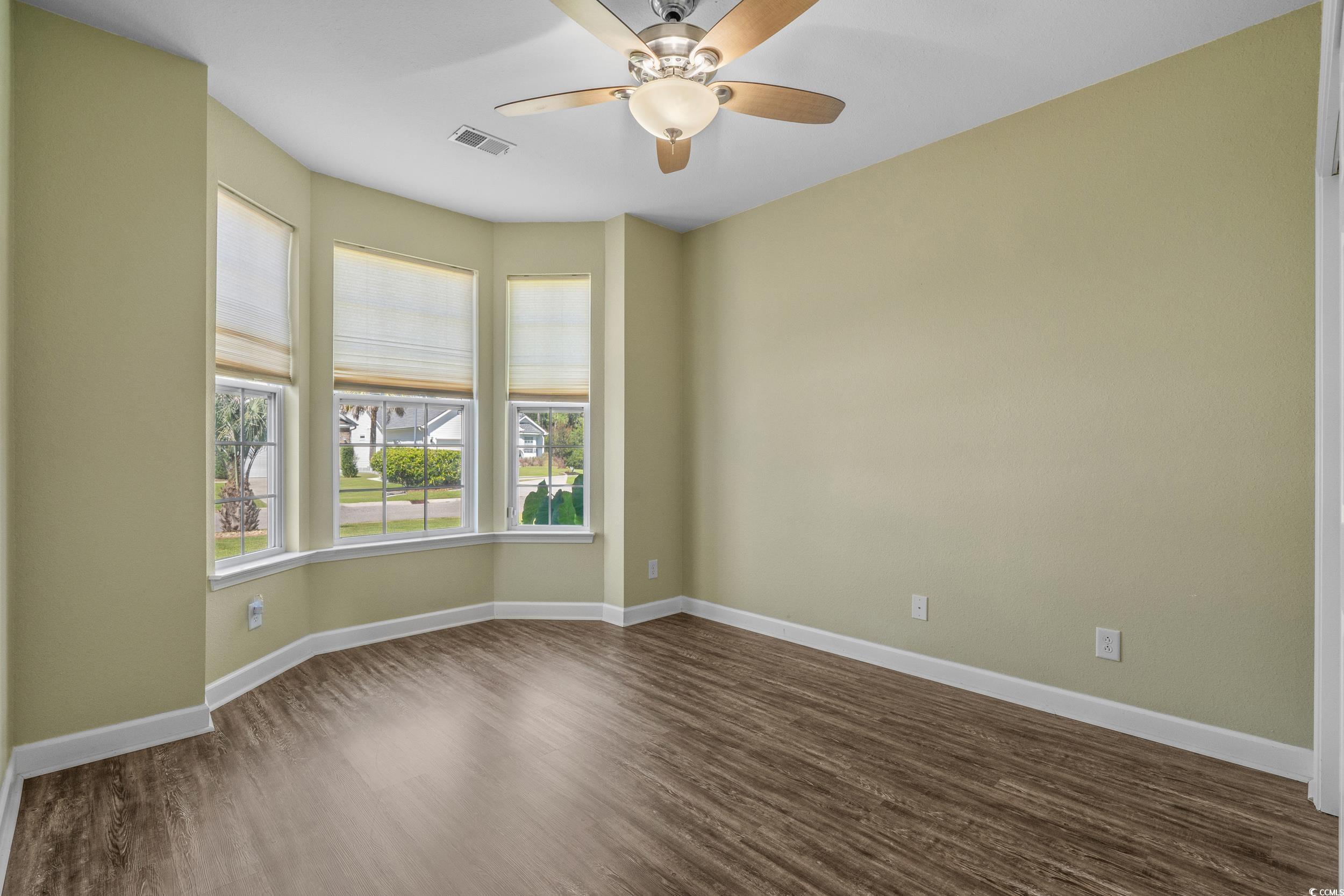 562 Tuckahoe Road Myrtle Beach, SC 29579 - Photo 20 of 40 Empty room with dark wood-type flooring and a ceiling fan