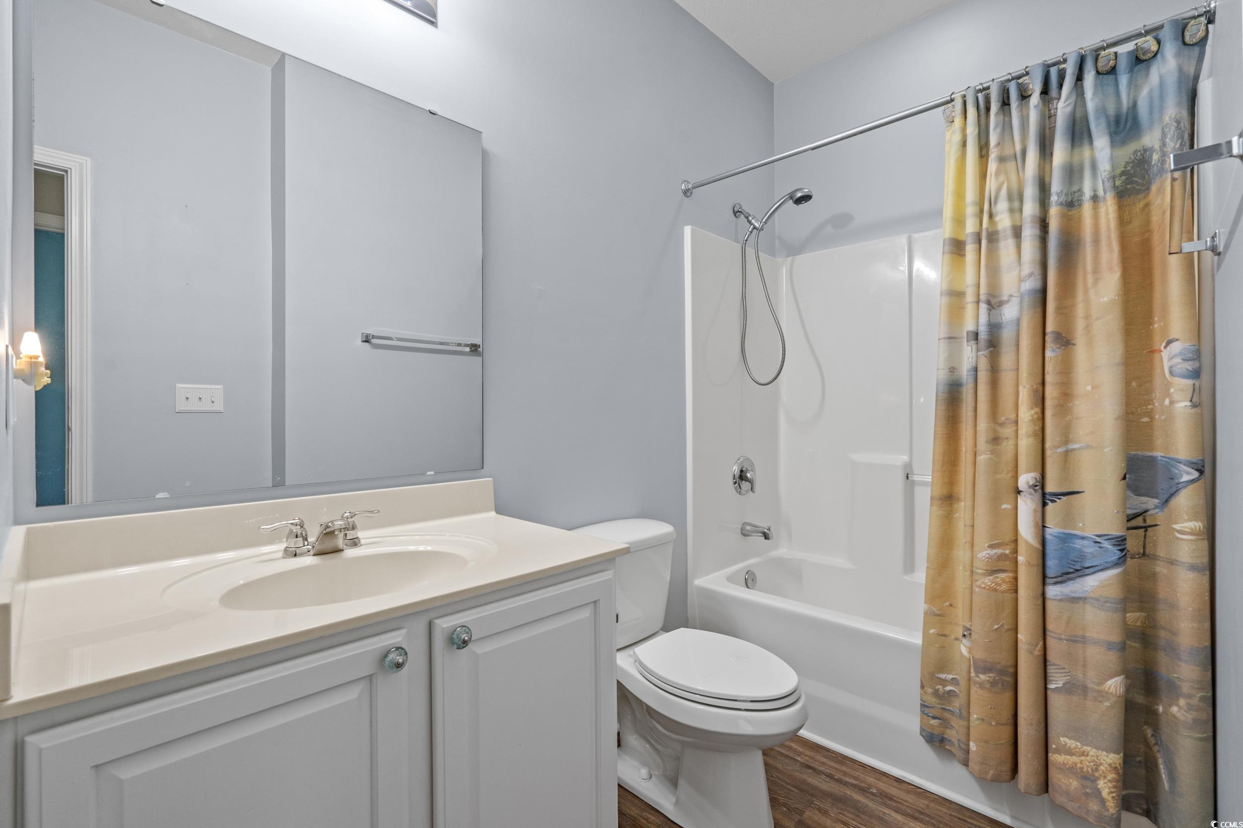 562 Tuckahoe Road Myrtle Beach, SC 29579 - Photo 24 of 40 Bathroom featuring shower / tub combo, vanity, and dark wood finished floors