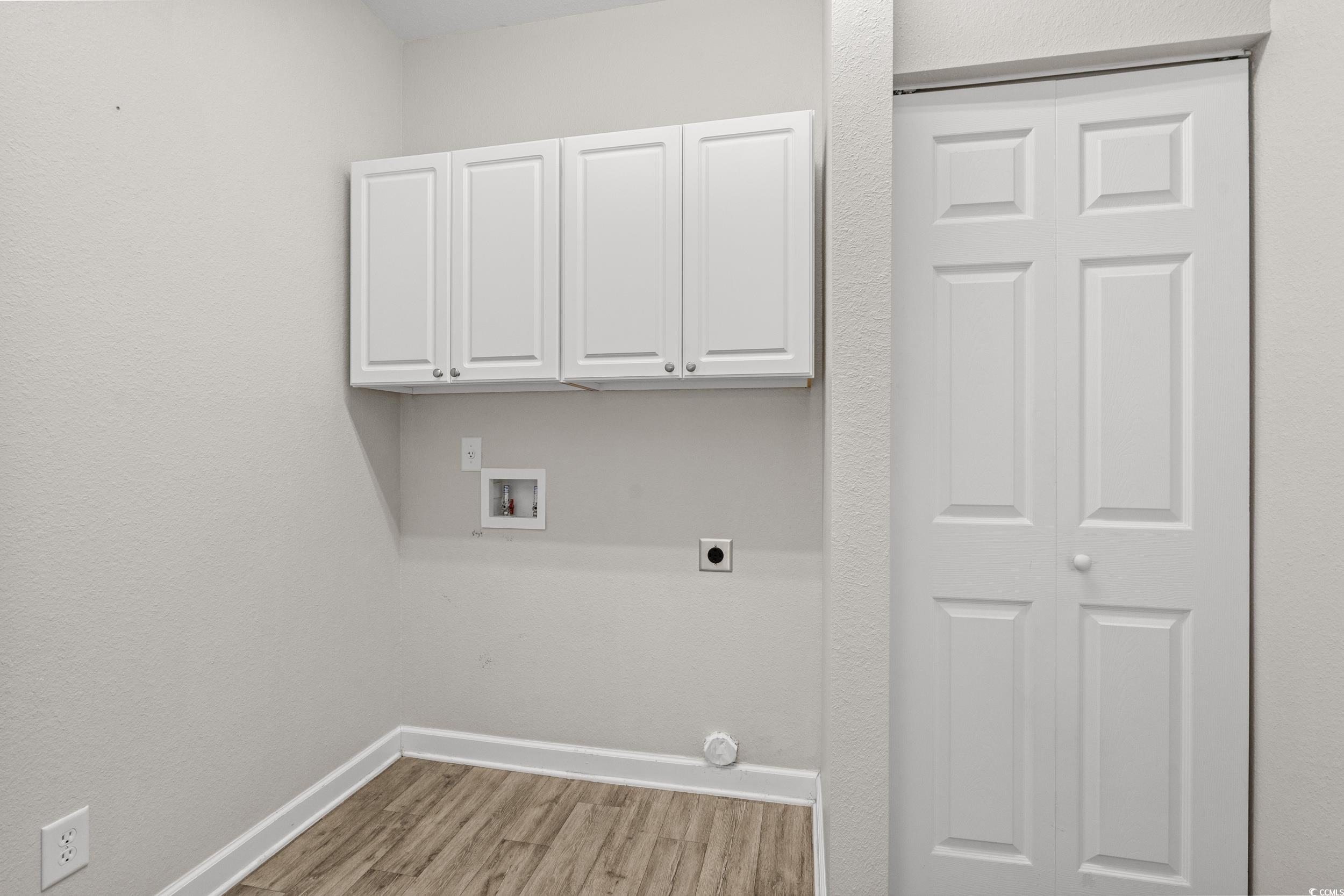 562 Tuckahoe Road Myrtle Beach, SC 29579 - Photo 25 of 40 Washroom featuring light wood finished floors, washer hookup, cabinet space, electric dryer hookup, and a textured wall