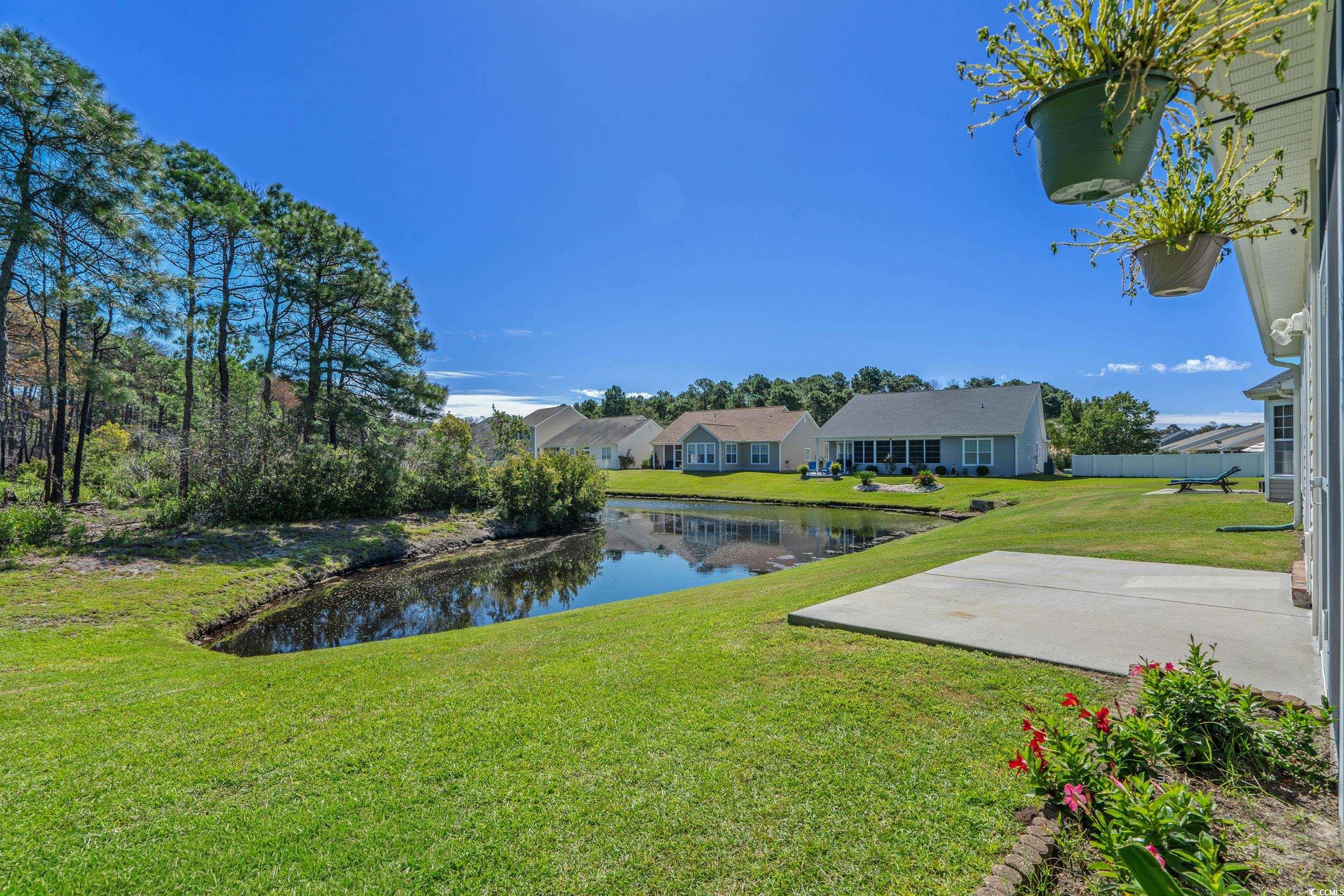 562 Tuckahoe Road Myrtle Beach, SC 29579 - Photo 29 of 40 View of green lawn featuring a water view, a patio area, and a residential view