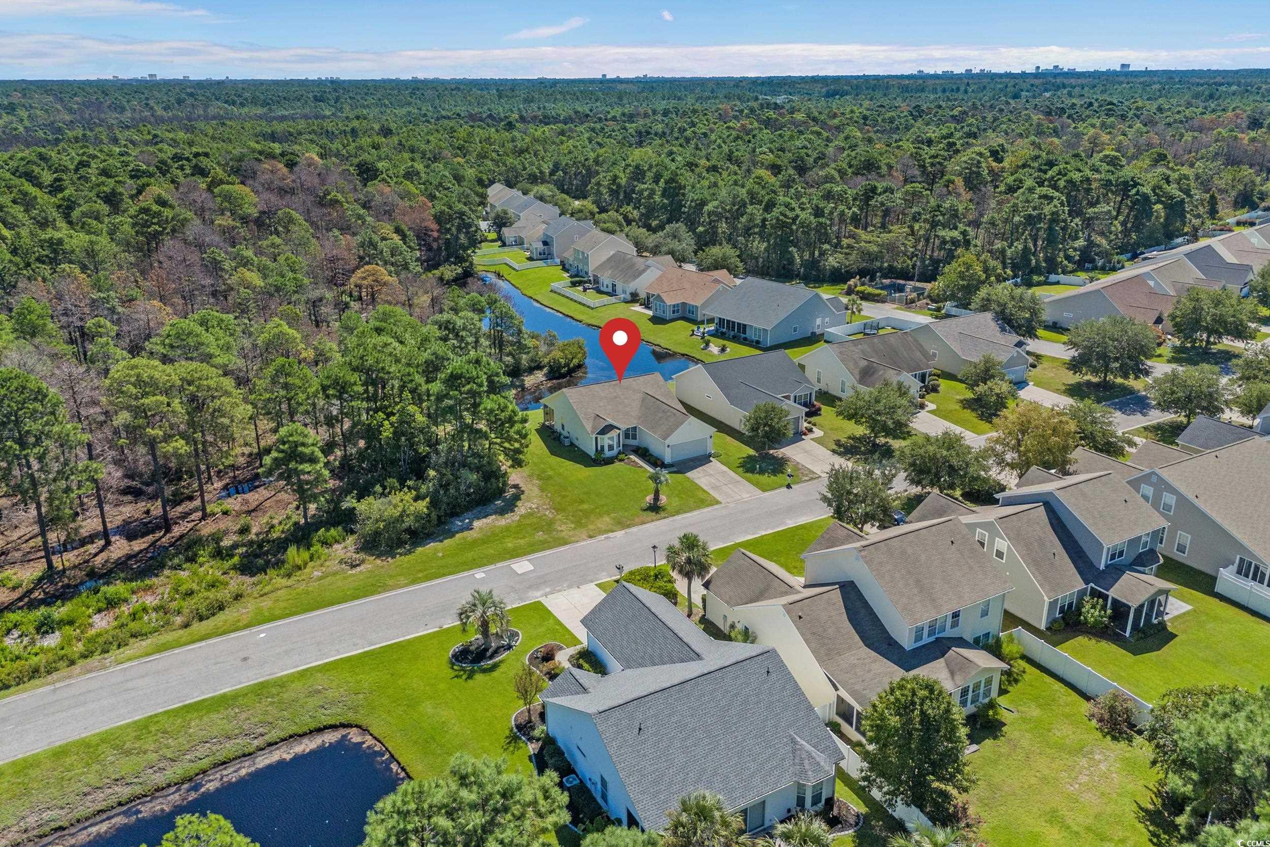 562 Tuckahoe Road Myrtle Beach, SC 29579 - Photo 30 of 40 Aerial perspective of suburban area featuring a nearby body of water and a heavily wooded area