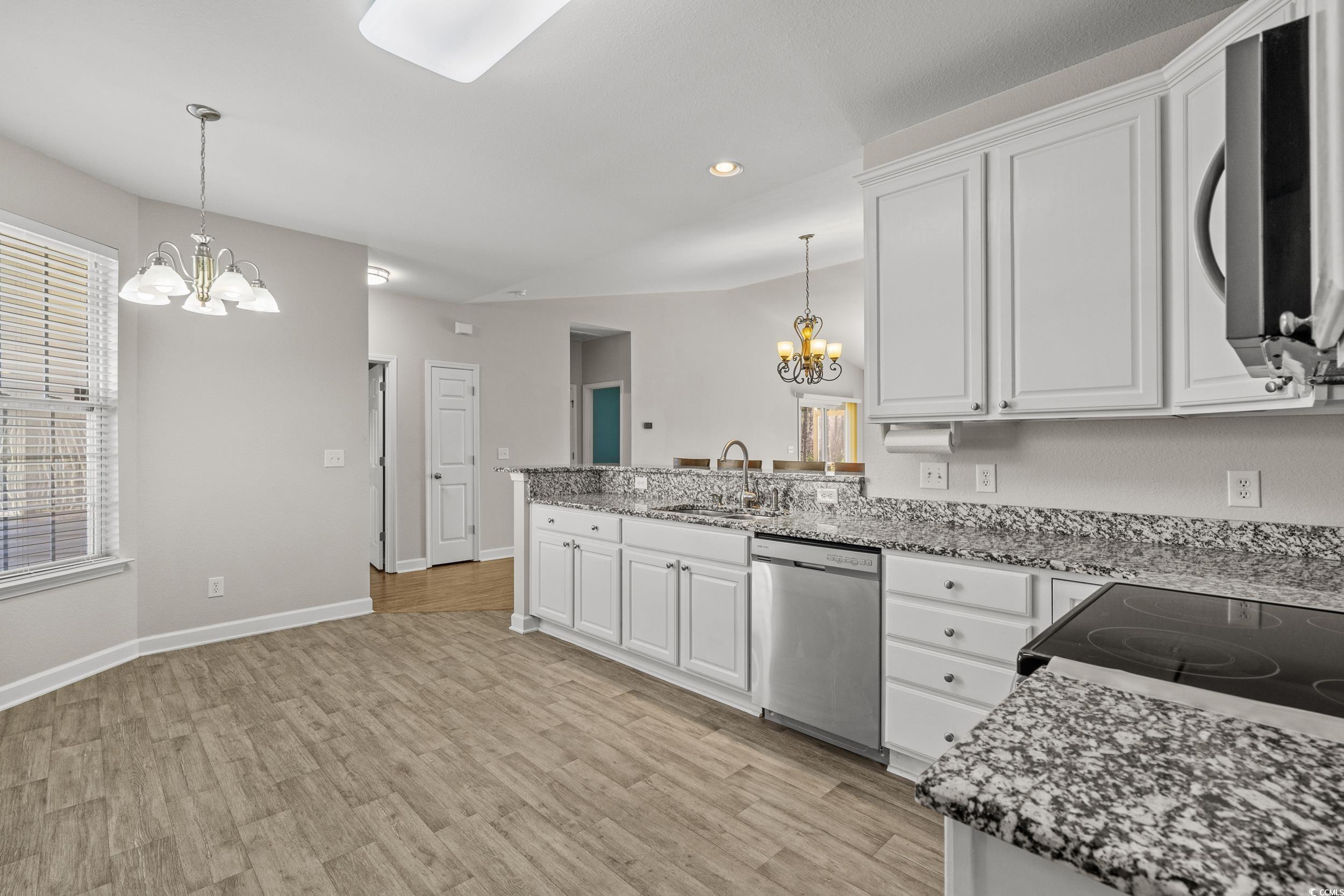562 Tuckahoe Road Myrtle Beach, SC 29579 - Photo 4 of 40 Kitchen with a chandelier, white cabinets, light wood-style floors, pendant lighting, and recessed lighting