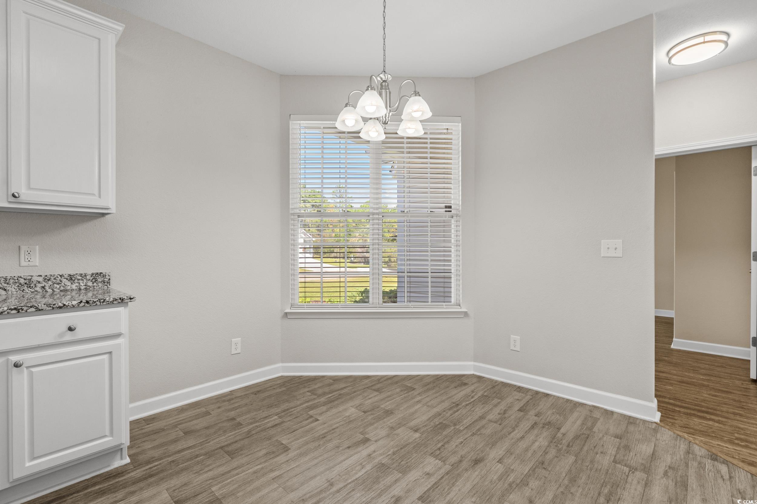 562 Tuckahoe Road Myrtle Beach, SC 29579 - Photo 8 of 40 Unfurnished dining area featuring light wood finished floors and a chandelier