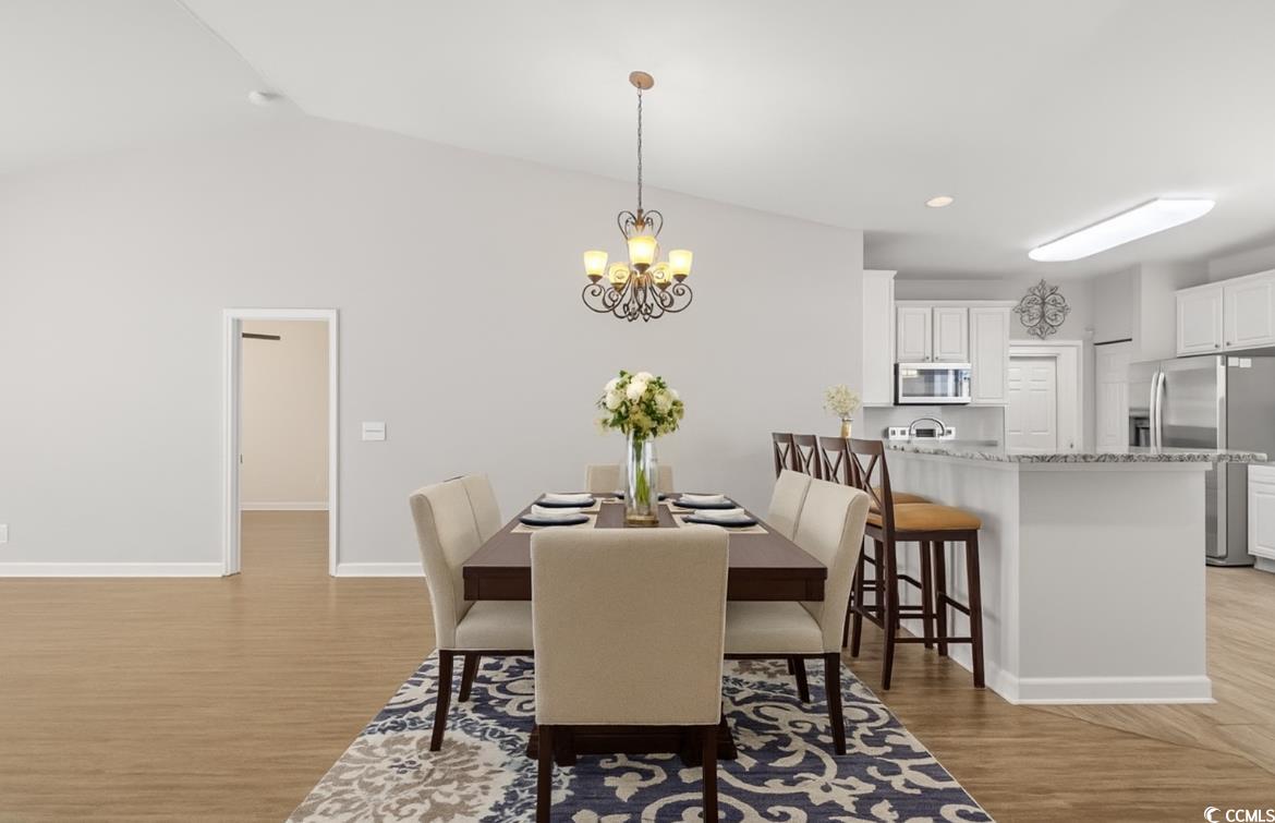 562 Tuckahoe Road Myrtle Beach, SC 29579 - Photo 10 of 40 Dining room with light wood-style floors, lofted ceiling, a chandelier, and recessed lighting