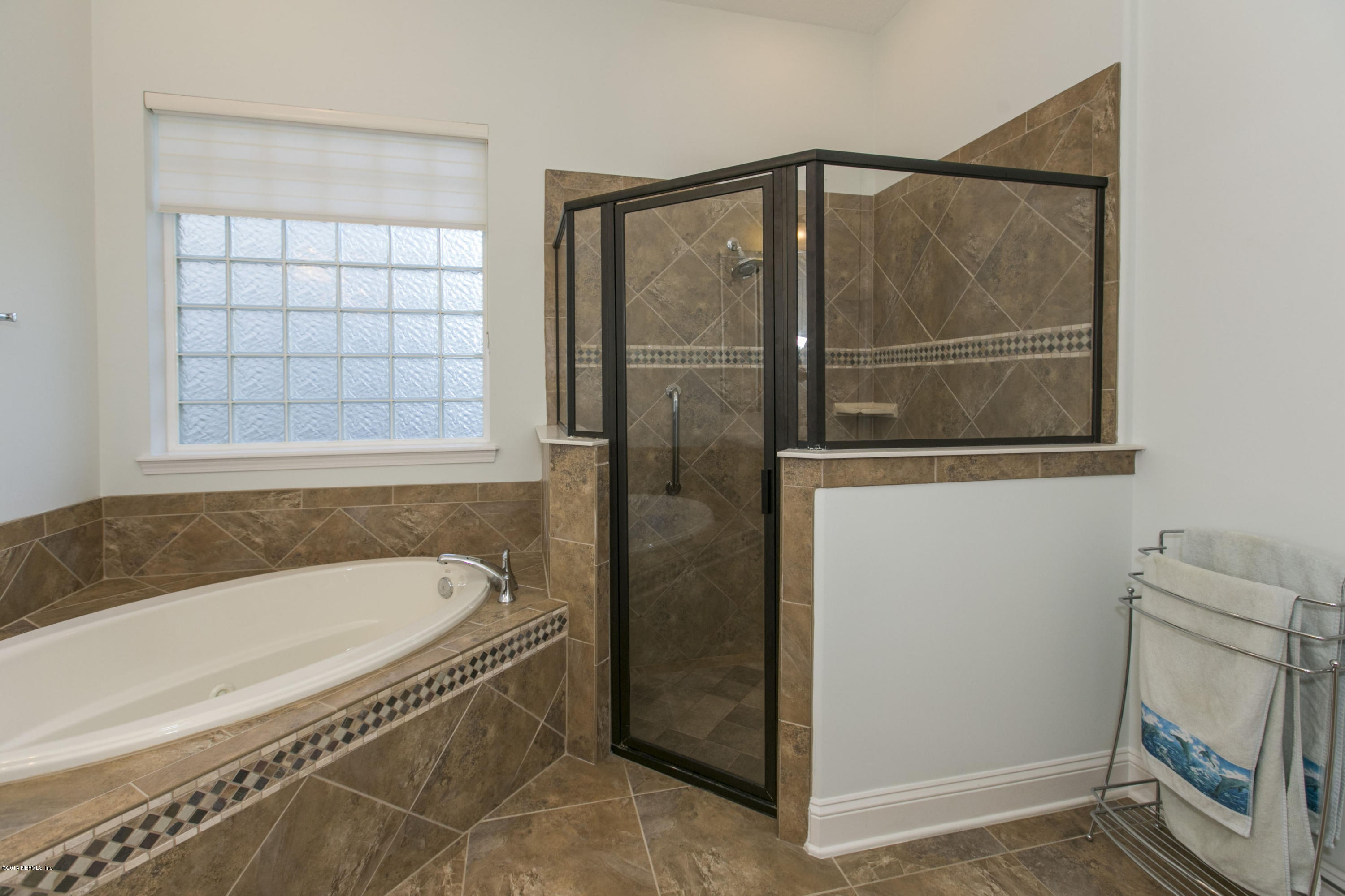 58 Pelican Pointe Road Ponte Vedra, FL 32081 - Photo 12 of 28 a bathroom with a bathtub and a shower