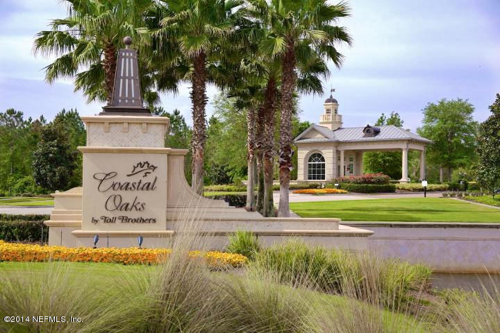 58 Pelican Pointe Road Ponte Vedra, FL 32081 - Photo 23 of 28 a front view of a house with a garden and swimming pool
