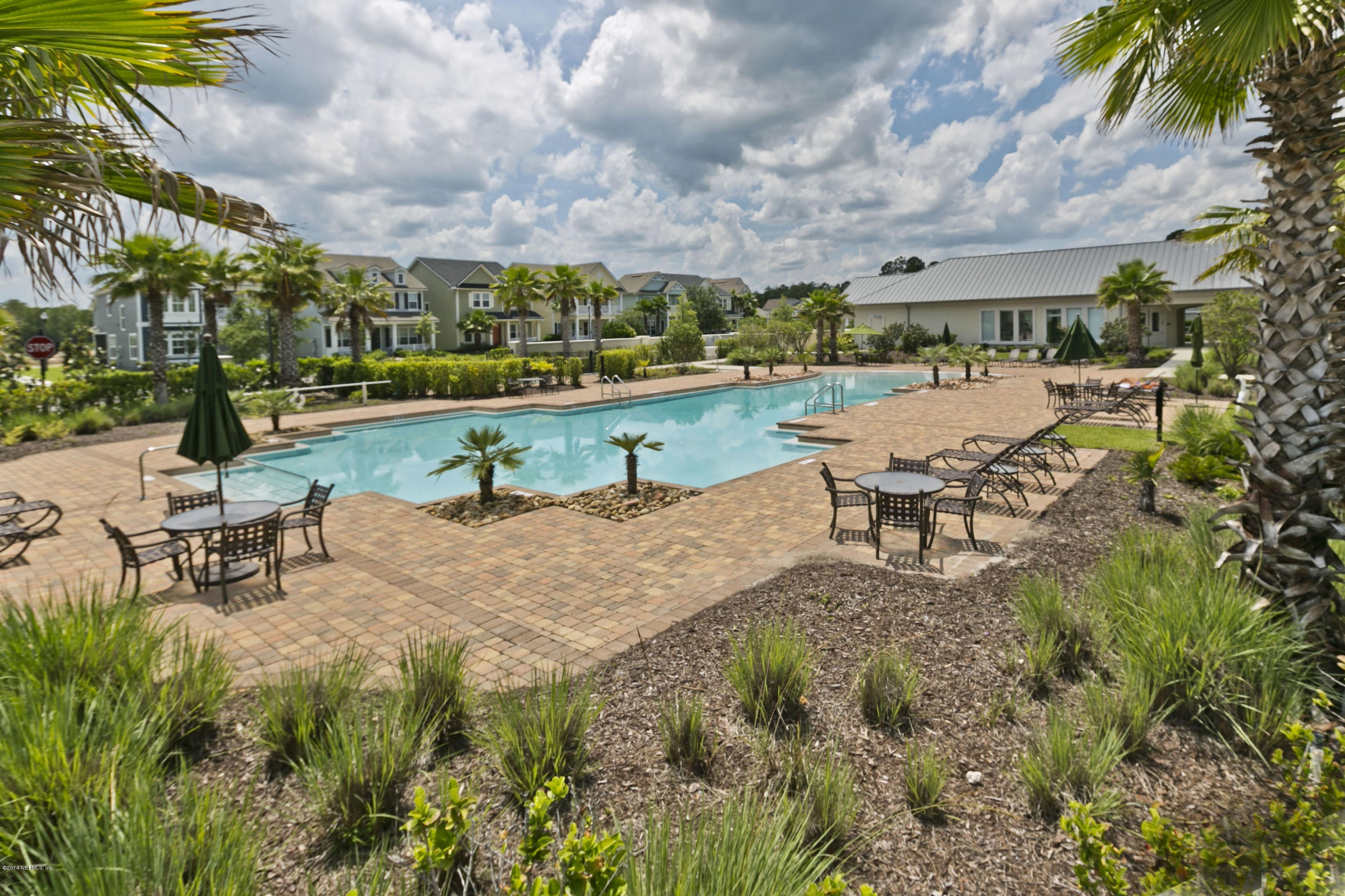 58 Pelican Pointe Road Ponte Vedra, FL 32081 - Photo 25 of 28 a view of a lake with a bench and a fountain