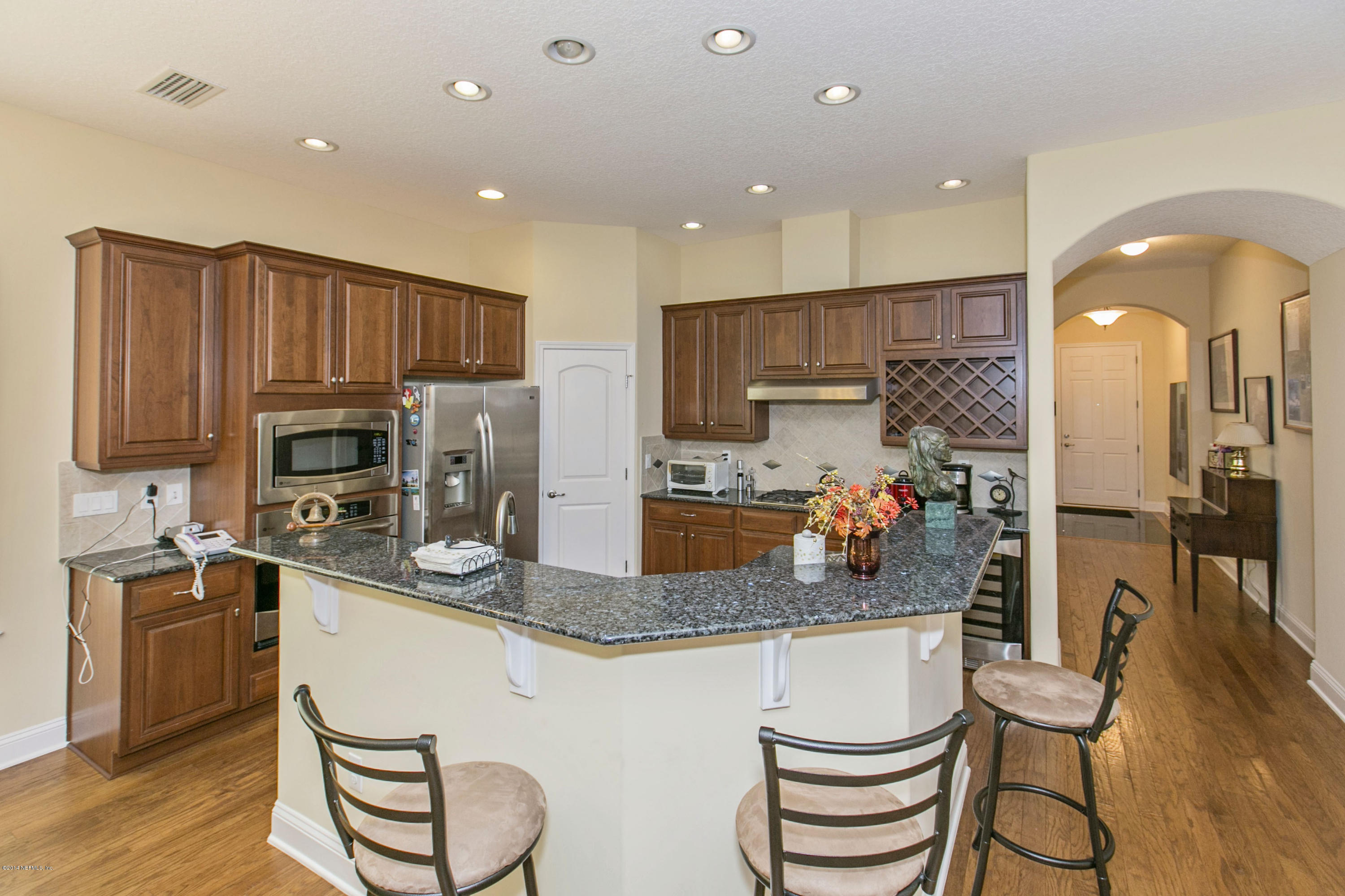58 Pelican Pointe Road Ponte Vedra, FL 32081 - Photo 4 of 28 a kitchen with stainless steel appliances granite countertop a sink refrigerator and cabinets