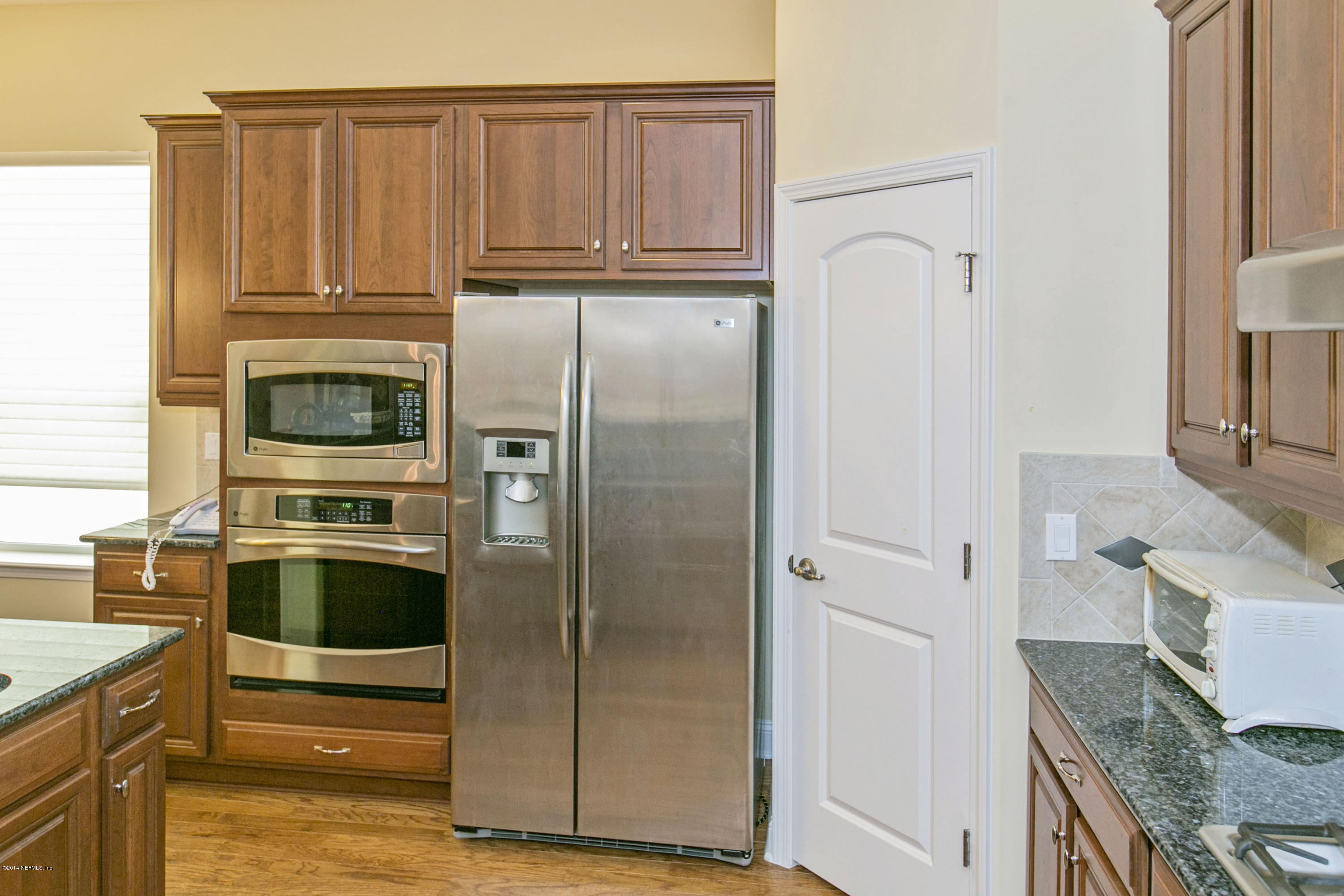 58 Pelican Pointe Road Ponte Vedra, FL 32081 - Photo 5 of 28 a kitchen with stainless steel appliances granite countertop a refrigerator and a stove