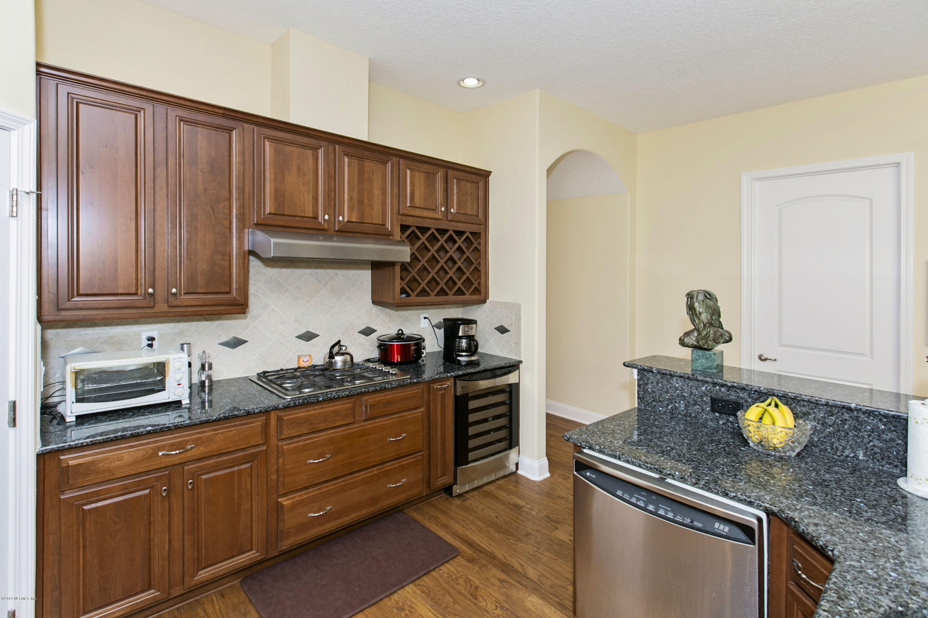 58 Pelican Pointe Road Ponte Vedra, FL 32081 - Photo 6 of 28 a kitchen with stainless steel appliances granite countertop a sink stove and cabinets