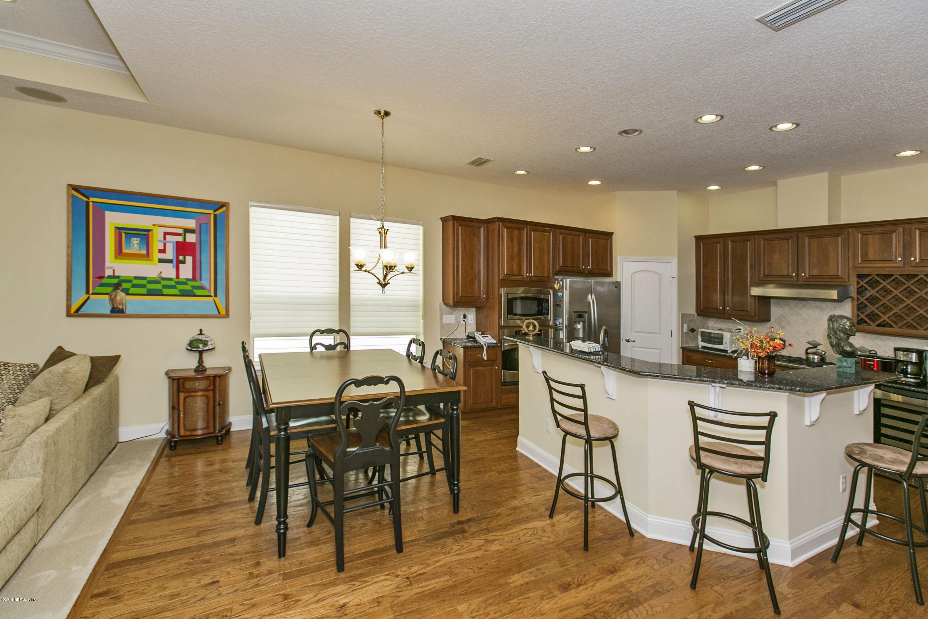 58 Pelican Pointe Road Ponte Vedra, FL 32081 - Photo 7 of 28 a view of a dining room with furniture a kitchen and chandelier