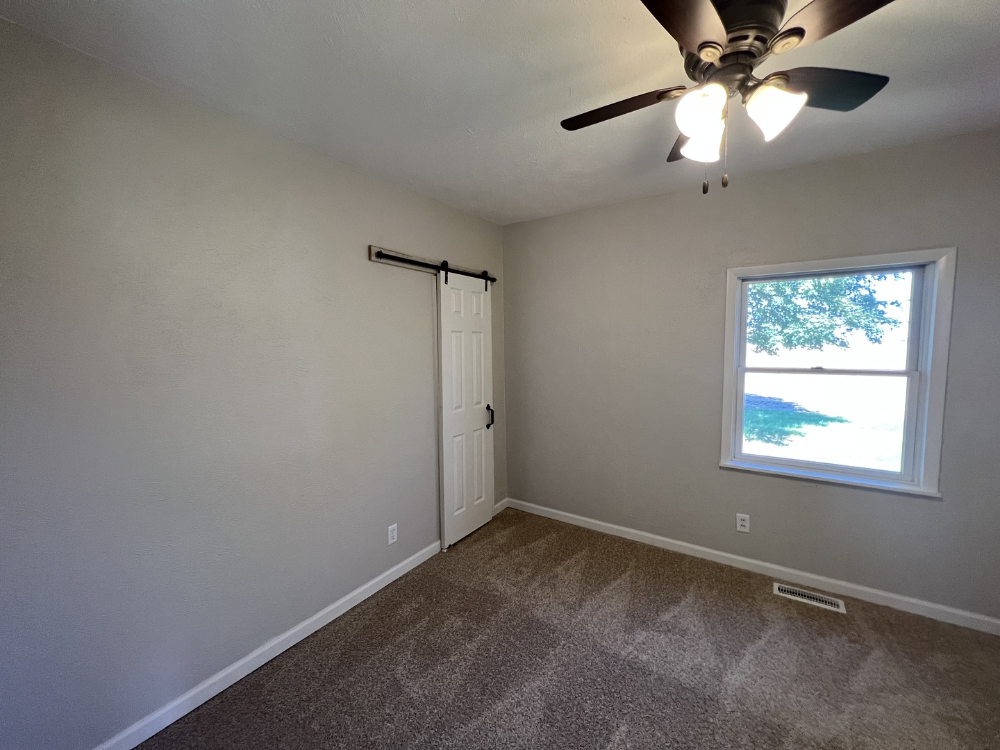 1980 West Grand Ridge Road Mazon, IL 60444 - Photo 9 of 21 an empty room with a window and a fan